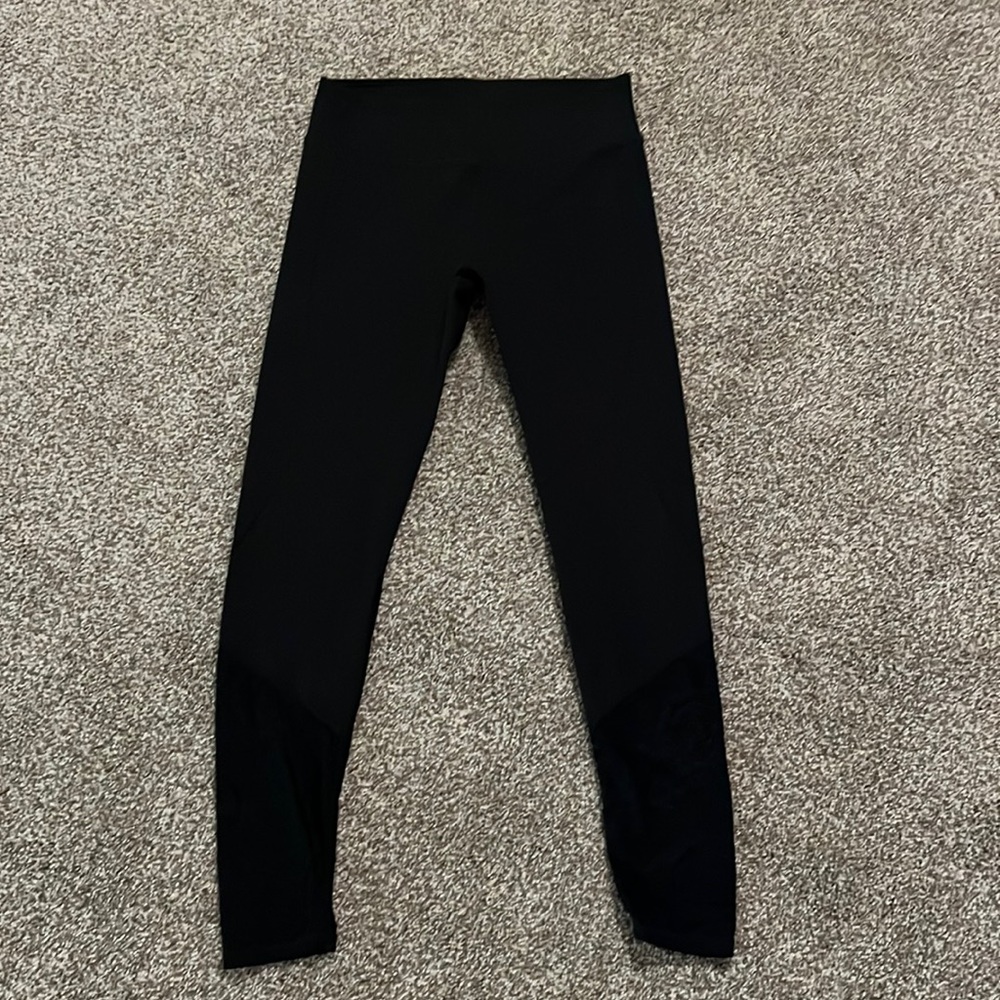 Black medium fabletic leggings with see through mesh on the calf